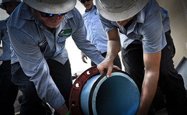 SLWSD Underground Utilities workers fixing a pipe's bolts